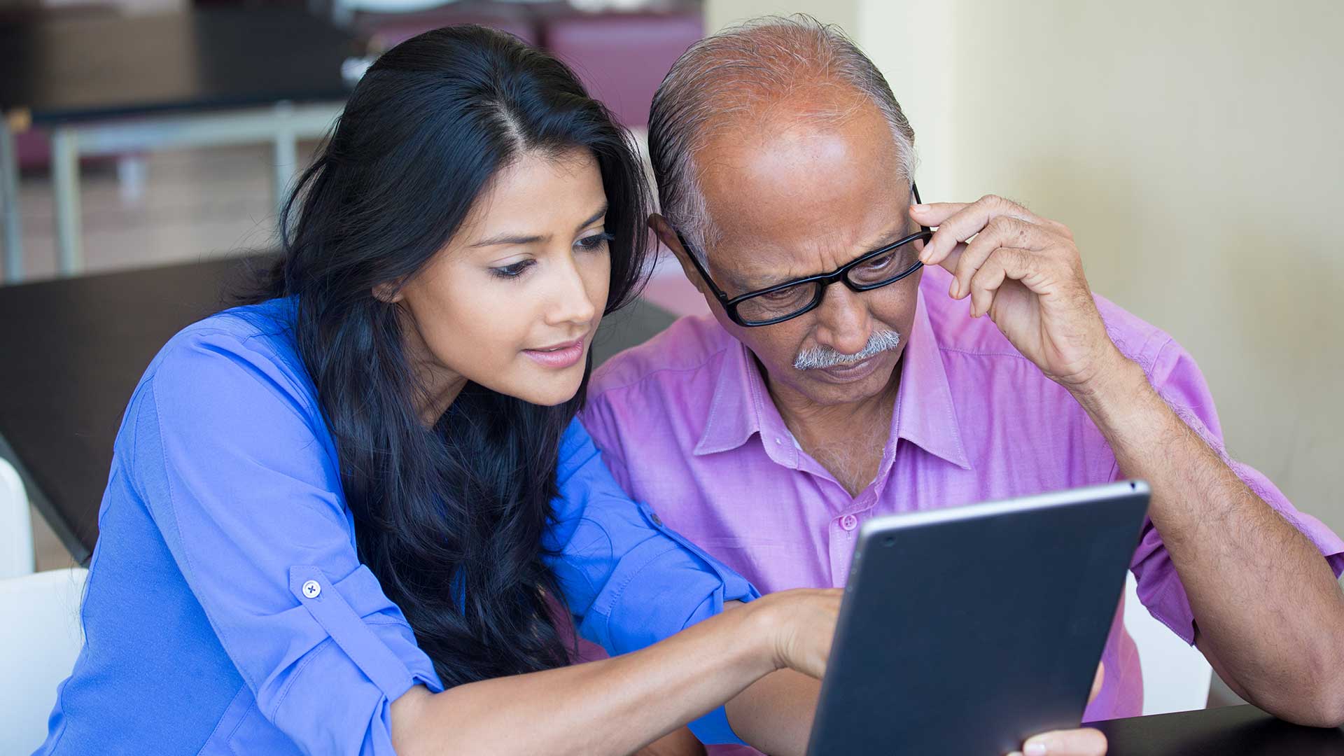 image depicts two people looking at an ipad to illustrate an example of ndis providers undertaking their ndis audit preparaion